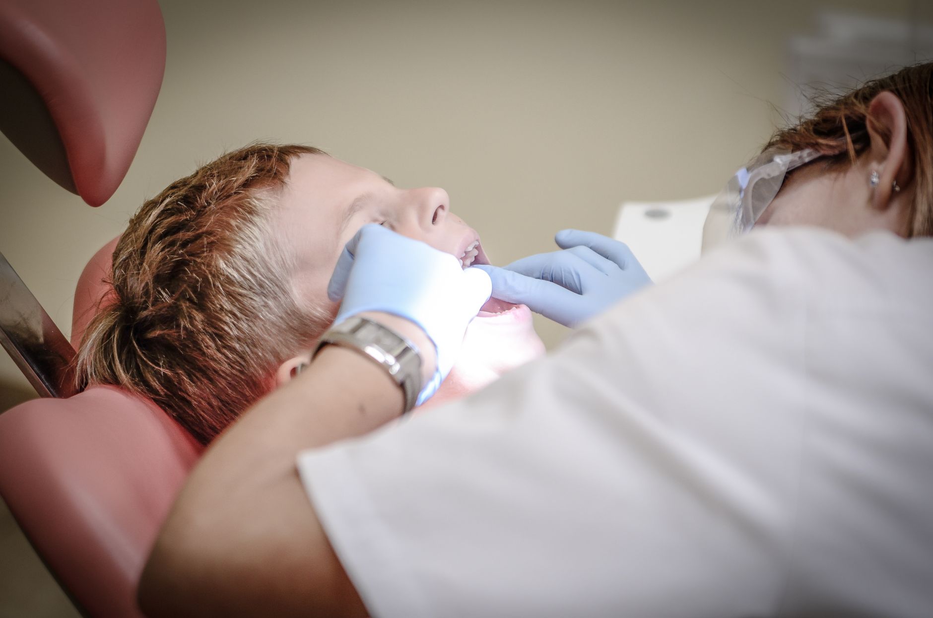 Chłopiec na fotelu u dentysty podczas badania stomatologicznego